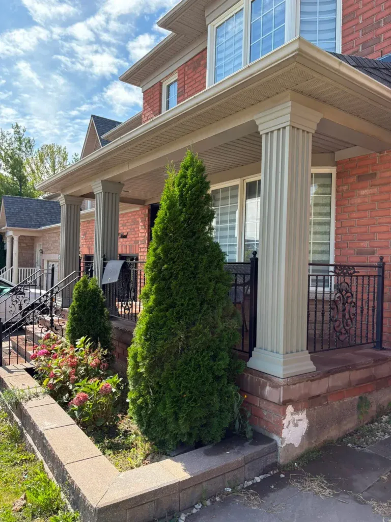 Front porch column with a damaged area at the base before stucco repair