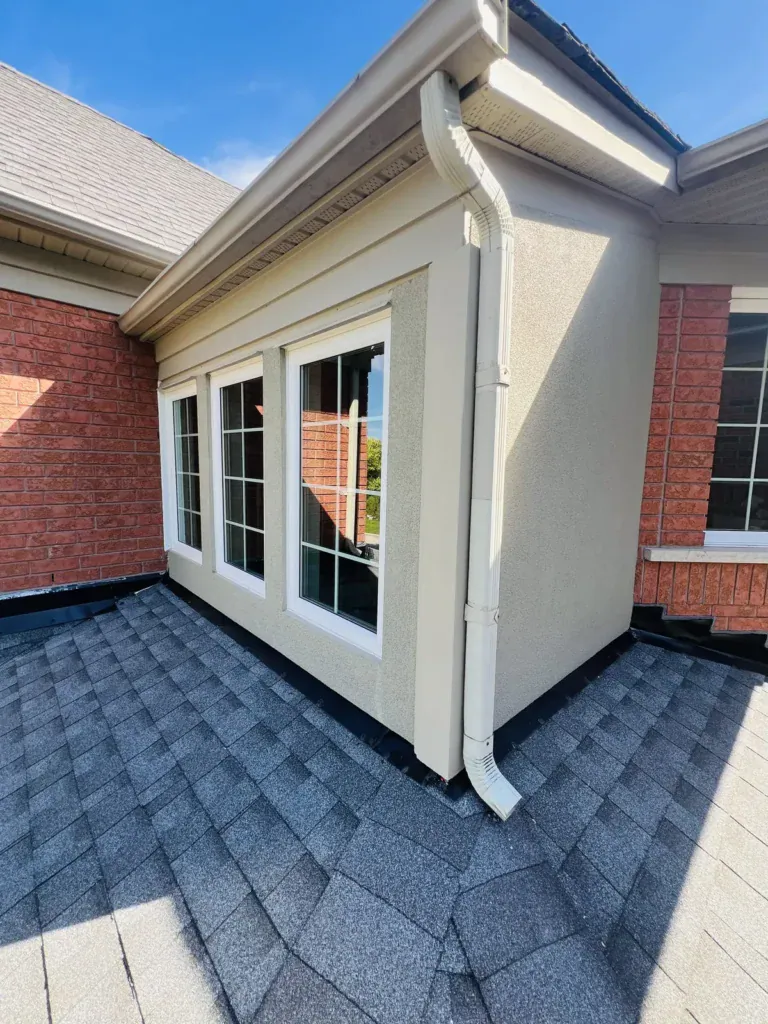After: refinished stucco corner and window surrounds on a roof-level bump-out