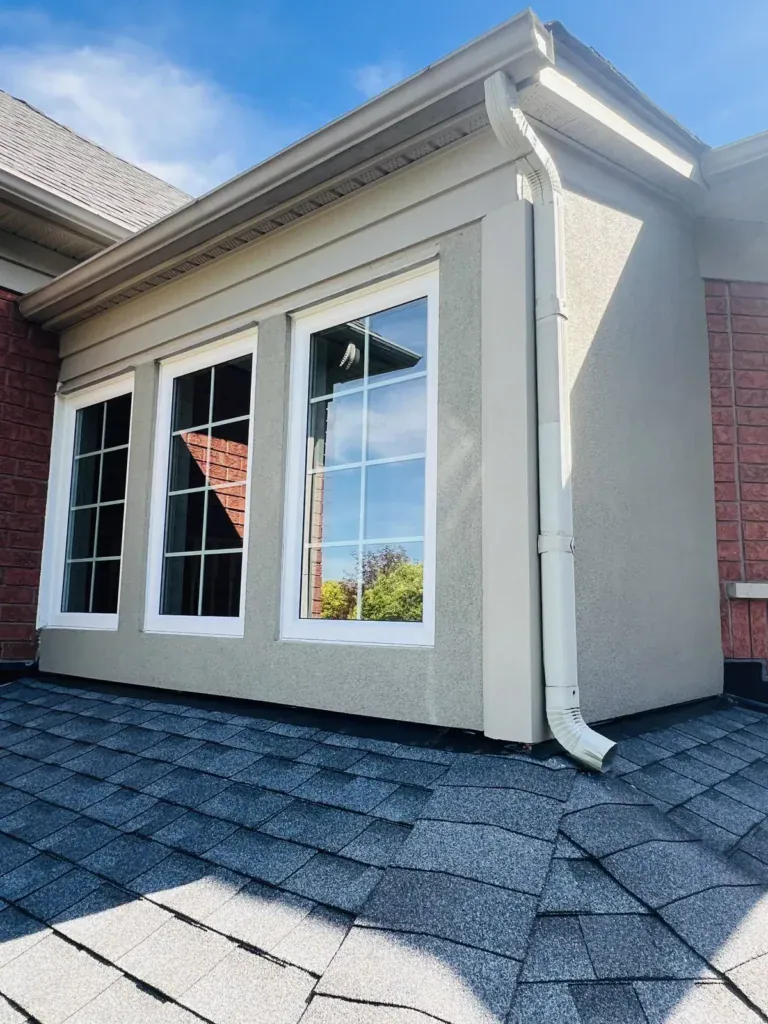 After: bump-out wall above the roof refinished in smooth beige stucco